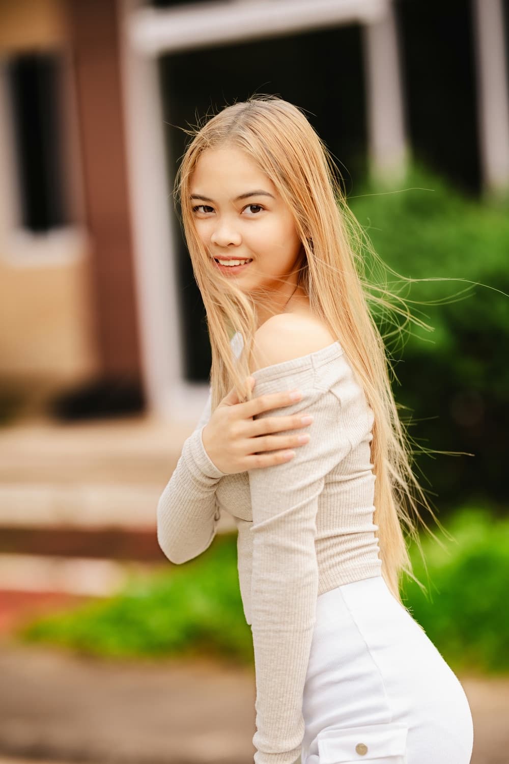Woman smiling in front of a house